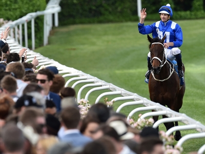 Hugh Bowman reacts after riding Winx to victory in the Cox Plate